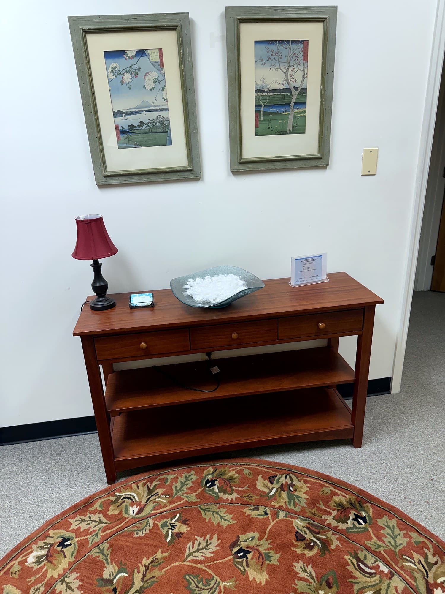 A quiet corner of Elisabeth Coffey's Florham Park office — console table with Japanese prints